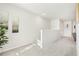 Upstairs hallway with carpet, white walls, and neutral decor, leading to additional rooms at 2015 Wyndham Pl, Conyers, GA 30013
