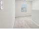 Bright hallway featuring neutral walls and carpet with a window on the right at 2015 Wyndham Pl, Conyers, GA 30013