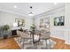 Stylish dining room with modern decor, hardwood floors, and bright natural light at 3258 Country Walk Dr, Powder Springs, GA 30127