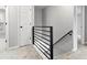 Upstairs hallway featuring gray walls, carpet, and a modern black railing for stairs to the next level at 3258 Country Walk Dr, Powder Springs, GA 30127