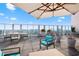 A rooftop terrace with an outdoor dining set and lounge chairs with umbrella at 4561 Olde Perimeter Way # 2707, Atlanta, GA 30346