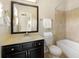 Traditional bathroom featuring dark vanity, a framed mirror, and shower/tub combo at 1365 Hawthorne Se Ave, Smyrna, GA 30080