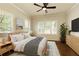 Bright primary bedroom with ceiling fan, hardwood floors, and large windows for ample natural light at 1365 Hawthorne Se Ave, Smyrna, GA 30080