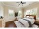 Bright bedroom with hardwood floors, ceiling fan, and natural light from windows with shutters at 1365 Hawthorne Se Ave, Smyrna, GA 30080