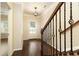 Inviting entryway featuring hardwood floors, stairs, decorative railing, and natural light at 1365 Hawthorne Se Ave, Smyrna, GA 30080