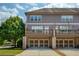 Townhouse with two-car garage, second story deck, and neutral gray siding at 1365 Hawthorne Se Ave, Smyrna, GA 30080