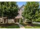 Traditional brick townhome with lush trees and greenery at 1365 Hawthorne Se Ave, Smyrna, GA 30080