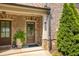 Charming brick home entrance with a well-manicured landscape and a cozy, inviting front door at 1365 Hawthorne Se Ave, Smyrna, GA 30080