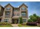Charming two-story brick townhome featuring beautiful landscaping and a covered front porch at 1365 Hawthorne Se Ave, Smyrna, GA 30080