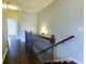Hallway featuring hardwood floors, stairs, decorative railing, and natural light at 1365 Hawthorne Se Ave, Smyrna, GA 30080