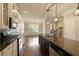 Well-lit kitchen with stainless steel appliances, an island with bar seating, and dark countertops at 1365 Hawthorne Se Ave, Smyrna, GA 30080