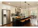 Elegant kitchen with stainless steel appliances, a large island with seating, and modern pendant lighting at 1365 Hawthorne Se Ave, Smyrna, GA 30080