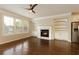 Spacious living room with hardwood floors, fireplace, built-in shelving, and lots of natural light at 1365 Hawthorne Se Ave, Smyrna, GA 30080