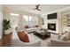 Bright living room with a fireplace, built-in shelving, and large windows at 1365 Hawthorne Se Ave, Smyrna, GA 30080