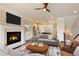 Cozy living room with a fireplace, a comfortable sofa, and an open view into the kitchen at 1365 Hawthorne Se Ave, Smyrna, GA 30080