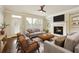 Inviting living room featuring a fireplace, built-in shelves, neutral decor, and large windows at 1365 Hawthorne Se Ave, Smyrna, GA 30080
