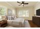 Comfortable main bedroom features a ceiling fan, light neutral walls and carpet, with nice natural light at 1365 Hawthorne Se Ave, Smyrna, GA 30080