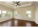 Bright main bedroom features tray ceiling, hardwood floors, and large windows at 1365 Hawthorne Se Ave, Smyrna, GA 30080