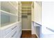 Bright walk-in closet featuring custom shelving, drawer storage, and hardwood flooring, offering ample space and organization at 1365 Hawthorne Se Ave, Smyrna, GA 30080