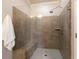 Luxurious walk-in shower featuring frameless glass, a built-in bench, tiled walls, and modern fixtures at 1365 Hawthorne Se Ave, Smyrna, GA 30080
