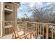 Balcony view with wood chairs overlooking greenery and neighborhood at 2865 Lenox Ne Rd # 410, Atlanta, GA 30324