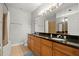 Bathroom featuring a double sink vanity with granite countertops and warm wooden cabinetry at 2865 Lenox Ne Rd # 410, Atlanta, GA 30324