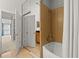 Updated bathroom with a soaking tub, shower, and a large mirrored closet door at 2865 Lenox Ne Rd # 410, Atlanta, GA 30324