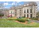 Upscale apartment building featuring manicured landscaping, a circular driveway, and mature trees at 2865 Lenox Ne Rd # 410, Atlanta, GA 30324