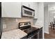 Contemporary kitchen featuring stainless steel appliances and sleek granite countertops at 2865 Lenox Ne Rd # 410, Atlanta, GA 30324