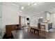 Bright open-concept living space with modern lighting and an adjacent kitchen bar area at 2865 Lenox Ne Rd # 410, Atlanta, GA 30324