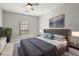 Comfortable main bedroom featuring a ceiling fan, soft carpet, and modern decor at 2865 Lenox Ne Rd # 410, Atlanta, GA 30324
