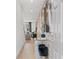 Bright hallway featuring light wood floors, modern art, and a stylish console table with seating at 309 Heavenly Hollow Pl, Mcdonough, GA 30253