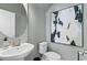 Stylish powder room features a modern vanity, round mirror, and elegant fixtures against a neutral backdrop at 309 Heavenly Hollow Pl, Mcdonough, GA 30253