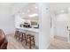 Open-concept kitchen with a breakfast bar and sleek white cabinetry, blending style and functionality at 384 Teal Ct, Roswell, GA 30076