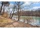 Scenic river view with sunlight shimmering on the water, framed by trees on a sunny day, offering a serene natural backdrop at 384 Teal Ct, Roswell, GA 30076