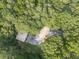 Aerial view of a home and detached garage surrounded by dense forest and greenery at 4422 Fincher Rd, Canton, GA 30114