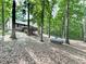 Secluded home with expansive backyard bordered by mature trees, accessed by wooden deck at 4422 Fincher Rd, Canton, GA 30114