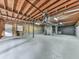 Unfinished basement with exposed ceiling, concrete flooring, and a white entry door at 4422 Fincher Rd, Canton, GA 30114
