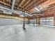 Unfinished basement with exposed ceiling, concrete flooring, and multiple garage doors at 4422 Fincher Rd, Canton, GA 30114