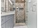 Modern bathroom featuring a tiled shower with a herringbone pattern and glass door at 4422 Fincher Rd, Canton, GA 30114