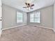 Carpeted bedroom featuring a ceiling fan and two bright windows at 4422 Fincher Rd, Canton, GA 30114