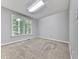 Carpeted bedroom featuring two bright windows and neutral walls at 4422 Fincher Rd, Canton, GA 30114