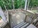 Staircase leading to an elevated deck with wood railing overlooking the backyard at 4422 Fincher Rd, Canton, GA 30114