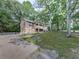 Charming home with covered porch, attached garage, and well-maintained lawn at 4422 Fincher Rd, Canton, GA 30114