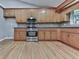 Traditional kitchen features stainless steel appliances, wood cabinets, and hardwood floors at 4422 Fincher Rd, Canton, GA 30114