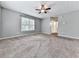 Bright living room with neutral walls, carpet, ceiling fan, and a window overlooking the yard at 4422 Fincher Rd, Canton, GA 30114
