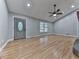Open living room features hardwood floors, a stylish front door, recessed lighting, and ceiling fan at 4422 Fincher Rd, Canton, GA 30114