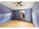 This bedroom has blue walls, a window with a wood covering, and a ceiling fan at 90 Oak Ridge Dr, Carrollton, GA 30116