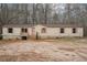 Home's exterior has beige siding, a small wooden porch, and landscaping at 90 Oak Ridge Dr, Carrollton, GA 30116