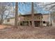 Home's back exterior with deck and natural landscape, blending indoor-outdoor living at 90 Oak Ridge Dr, Carrollton, GA 30116